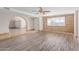 Inviting living room with stylish flooring, modern ceiling fan, and a brick accent wall at 3644 W Townley Ave, Phoenix, AZ 85051