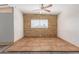 Bright living room with brick accent wall and tile floors at 3644 W Townley Ave, Phoenix, AZ 85051