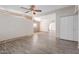 Bright living room with wood-look floors, ceiling fan, and light walls at 3644 W Townley Ave, Phoenix, AZ 85051