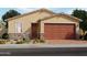 Charming single-story home with a two-car garage, stone accents, and a landscaped front yard at 3819 S 87Th Dr, Tolleson, AZ 85353
