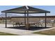 Inviting outdoor grilling area features modern grills, picnic tables, and mountain views for community gatherings at 3819 S 87Th Dr, Tolleson, AZ 85353