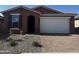 Beautiful single-story home with a two-car garage and a well-maintained, low-water landscaped front yard at 39980 W Anne Ln, Maricopa, AZ 85138