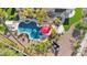 Aerial view of a backyard pool with a red umbrella, lounge area and surrounding landscaping at 4114 E Desert Cove Ave, Phoenix, AZ 85028