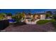Landscaped backyard featuring a small patio area, artificial turf, and mature landscaping at 4114 E Desert Cove Ave, Phoenix, AZ 85028