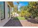 A lush backyard includes turf, rock beds, mature landscaping, and a tranquil sitting area at 4114 E Desert Cove Ave, Phoenix, AZ 85028