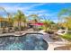 A beautifully landscaped backyard features a pristine pool, lounge seating, and a dining area at 4114 E Desert Cove Ave, Phoenix, AZ 85028