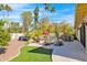 An expansive backyard features lush landscaping, an inground pool, and an outdoor dining area at 4114 E Desert Cove Ave, Phoenix, AZ 85028