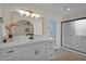 Bright bathroom with white vanity, updated fixtures, and a glass-enclosed shower at 4114 E Desert Cove Ave, Phoenix, AZ 85028