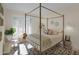 Sun-filled bedroom featuring a canopy bed, plantation shutters, and decorative accents at 4114 E Desert Cove Ave, Phoenix, AZ 85028