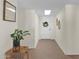 Inviting entryway with a white front door, a skylight, tile flooring, and stylish decor at 4114 E Desert Cove Ave, Phoenix, AZ 85028