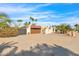 A single-story house boasts desert landscaping and a long driveway leading to a two-car garage at 4114 E Desert Cove Ave, Phoenix, AZ 85028