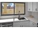 Bright kitchen featuring white cabinets, stainless steel appliances, and a garden window at 4114 E Desert Cove Ave, Phoenix, AZ 85028