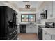 Modern kitchen with stainless steel appliances, white cabinets, and black hardware at 4114 E Desert Cove Ave, Phoenix, AZ 85028