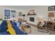 Stylish living room featuring hardwood floors, ample seating, and a painted brick fireplace at 4114 E Desert Cove Ave, Phoenix, AZ 85028
