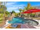 Lush backyard oasis featuring a waterfall, a pool, a lounge area, and mature palm trees at 4114 E Desert Cove Ave, Phoenix, AZ 85028
