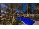 A tranquil pool area with waterfall feature, landscaping, and travertine tile offers a serene retreat at 4114 E Desert Cove Ave, Phoenix, AZ 85028