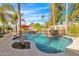A refreshing pool with a stone waterfall feature is surrounded by lush landscaping and comfortable seating at 4114 E Desert Cove Ave, Phoenix, AZ 85028