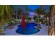 Backyard swimming pool features an umbrella and lounge chairs with beautiful sunset backdrop at 4114 E Desert Cove Ave, Phoenix, AZ 85028