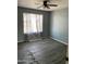 Bedroom featuring light blue walls, laminate floors and a window with curtains at 4115 W Sierra St, Phoenix, AZ 85029