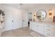 Well-lit bathroom with double vanity, modern fixtures, a round mirror, and ample storage space at 5045 E Calle Del Sol --, Cave Creek, AZ 85331