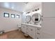 Modern bathroom with a double vanity, stylish mirrors, and neutral tile flooring at 5045 E Calle Del Sol --, Cave Creek, AZ 85331