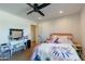 Comfortable bedroom with floral bedding, a ceiling fan, and a white vanity area at 5045 E Calle Del Sol --, Cave Creek, AZ 85331