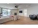 Primary bedroom with fireplace, TV, and access to the pool area, featuring tile flooring and neutral decor at 5045 E Calle Del Sol --, Cave Creek, AZ 85331