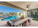 Spacious covered patio offering picturesque views of the pool and backyard oasis at 5045 E Calle Del Sol --, Cave Creek, AZ 85331