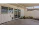 Back patio with covered seating area, brick privacy wall, and sliding glass door at 5112 N 83Rd St, Scottsdale, AZ 85250