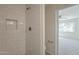 Bathroom shower with white subway tile, a built-in niche, and updated fixtures at 5112 N 83Rd St, Scottsdale, AZ 85250