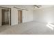 Spacious bedroom with a ceiling fan, sliding barn door, and plush carpet at 5112 N 83Rd St, Scottsdale, AZ 85250