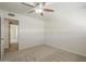 A clean carpeted bedroom featuring a ceiling fan and doorway at 5112 N 83Rd St, Scottsdale, AZ 85250
