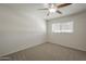 Carpeted bedroom featuring a ceiling fan and a bright window at 5112 N 83Rd St, Scottsdale, AZ 85250