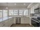 Updated kitchen with white cabinets, stainless steel appliances, and a spacious countertop at 5112 N 83Rd St, Scottsdale, AZ 85250