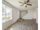 Bright living room featuring wood-look tile floors, a large window, and a staircase at 5112 N 83Rd St, Scottsdale, AZ 85250