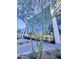 Contemporary commercial building with a striking glass facade, modern architectural design, and lush landscaping at 5303 N 7Th St # 242, Phoenix, AZ 85014