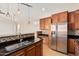 Modern kitchen with stainless steel appliances, granite countertops, and wooden cabinets in open layout at 5303 N 7Th St # 242, Phoenix, AZ 85014