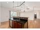 Open concept kitchen with modern appliances, dark granite countertops, and wood floors looking into dining area at 5303 N 7Th St # 242, Phoenix, AZ 85014
