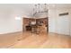 Open concept kitchen with wooden cabinets, granite countertops, pendant lighting, and hardwood floors at 5303 N 7Th St # 242, Phoenix, AZ 85014