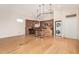 Open concept kitchen with wooden cabinets, granite countertops, pendant lighting, and hardwood floors at 5303 N 7Th St # 242, Phoenix, AZ 85014