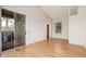 Bright room featuring light wood floors, a sliding glass door to balcony, and a large window at 5303 N 7Th St # 242, Phoenix, AZ 85014