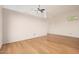 Spacious living room with light wood floors, white walls and a ceiling fan at 5303 N 7Th St # 242, Phoenix, AZ 85014