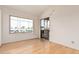 Bright room featuring light wood floors, a large window and sliding glass door to balcony at 5303 N 7Th St # 242, Phoenix, AZ 85014