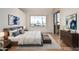 Serene main bedroom featuring a large window, soft natural light, and a stylish dresser with modern accents at 5303 N 7Th St # 242, Phoenix, AZ 85014