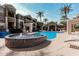 Resort-style pool area with palm trees, a hot tub, and lounge seating for relaxing and enjoying the outdoors at 5303 N 7Th St # 242, Phoenix, AZ 85014