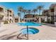 Community pool with hot tub, lounge chairs, shaded areas, and desert landscaping at 5303 N 7Th St # 242, Phoenix, AZ 85014