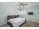 Bedroom with a bed and a TV with white shutters at 5434 W Desert Hills Dr, Glendale, AZ 85304