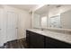 Modern bathroom with dark cabinets, granite countertops, and a framed mirror at 611 W Crowned Dove Trl, Casa Grande, AZ 85122