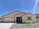 Inviting single-story home featuring a two-car garage and desert landscaping in front at 611 W Crowned Dove Trl, Casa Grande, AZ 85122