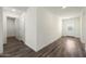 Bright hallway with dark vinyl floors and a view of the front door at 611 W Crowned Dove Trl, Casa Grande, AZ 85122